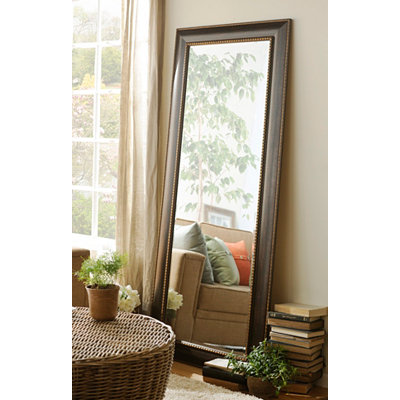 A large floor mirror will bring extra dimension to a small room.