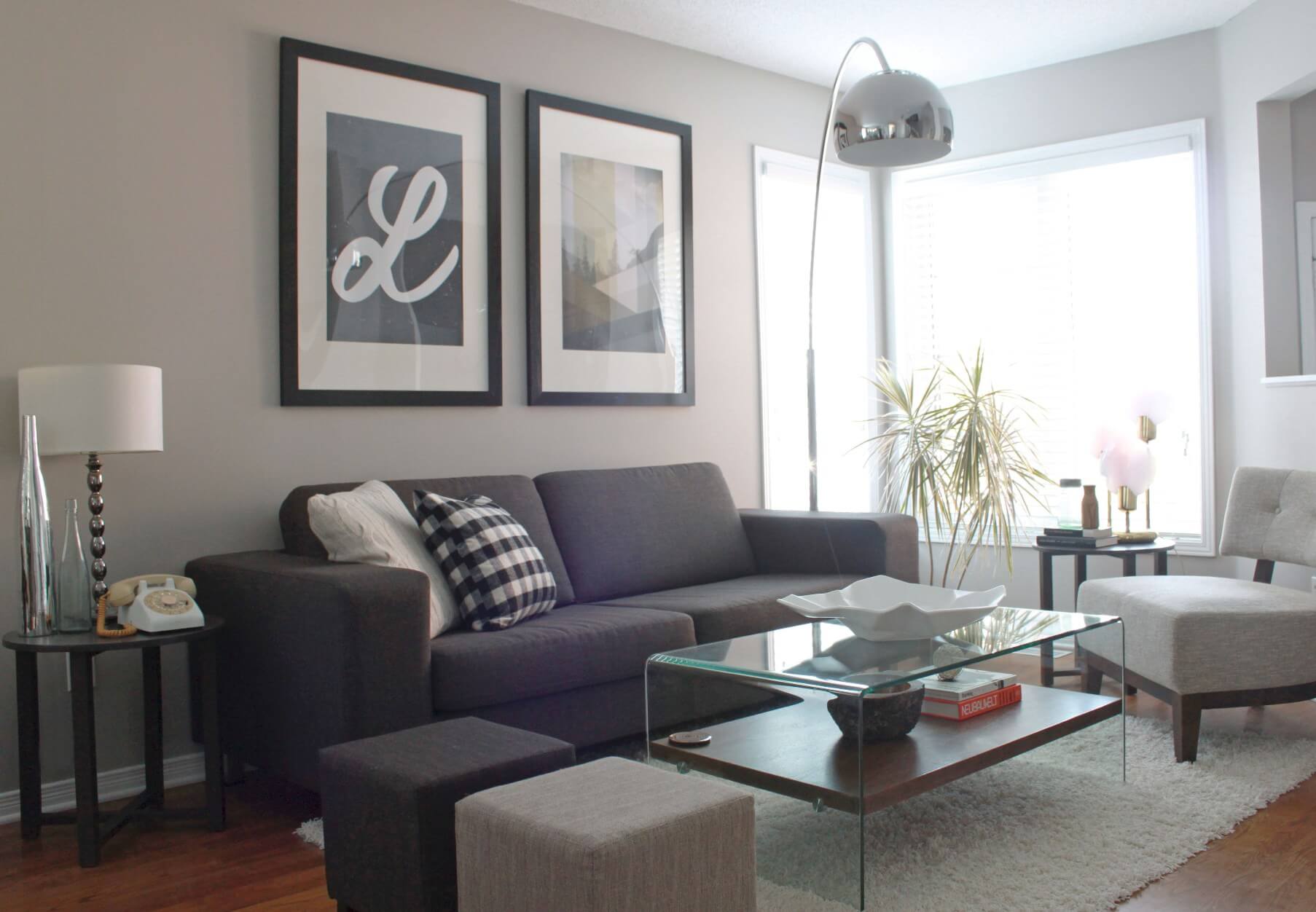 Small living room in gray neutral colors and lucite coffee table.