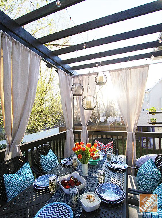 Make a covered outdoor dining area with elegant draperies.