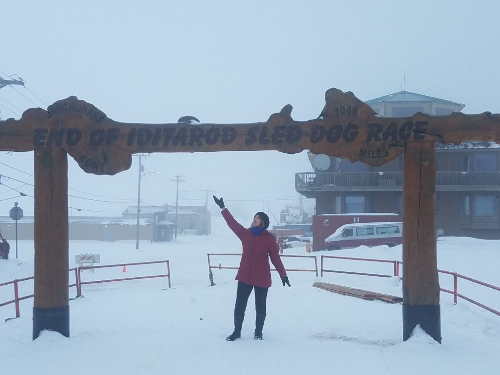 Me standing under the famous burled arch in Nome, Alaska.