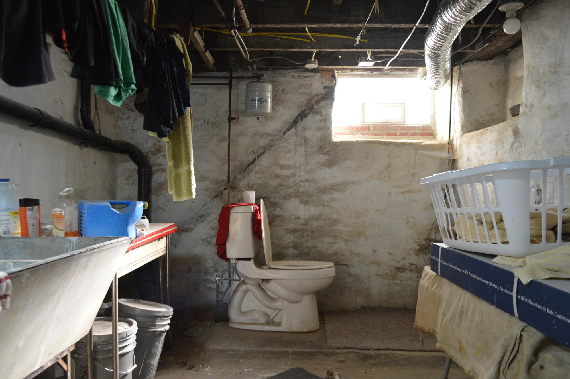 Unfinished and creepy basement laundry room.