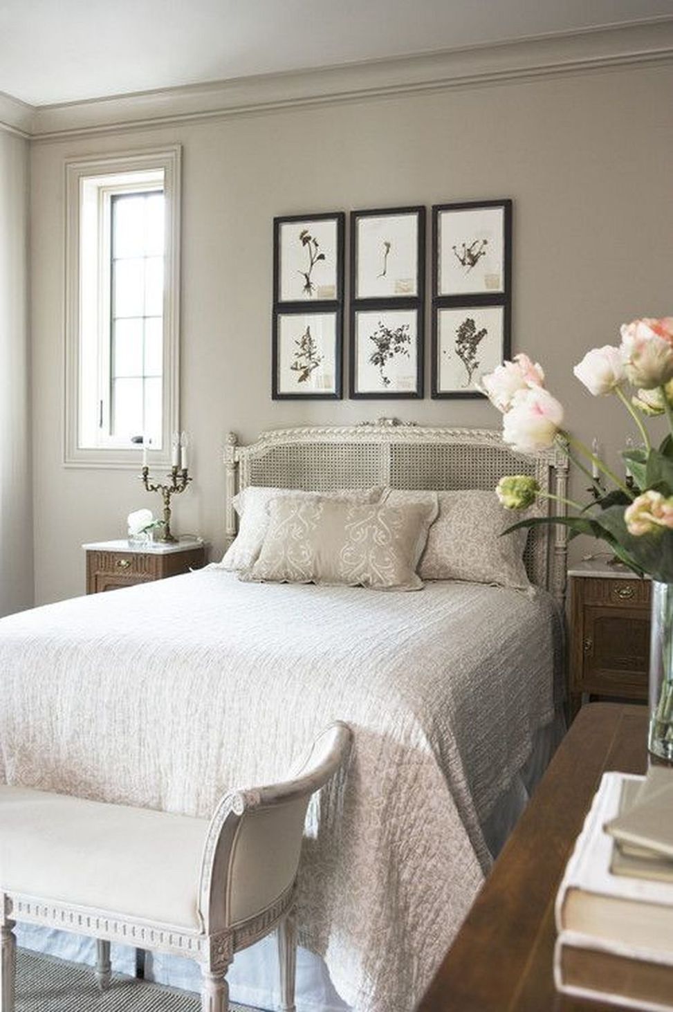Neutral colored bedroom with a bare window.