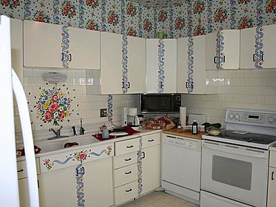 Kitchen with way too much wall paper design.