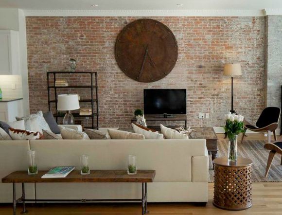 Living room with a brick focal wall.
