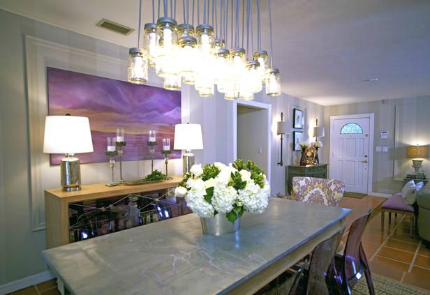 The dramatic light fixture above the dining table is a fantastic focal point.