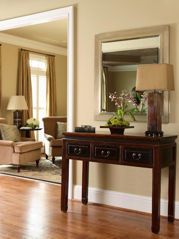 Create a focal point in the foyer with a table. lamp and mirror.