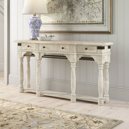 Soft neutral colors and a warm rug make this a welcoming foyer.