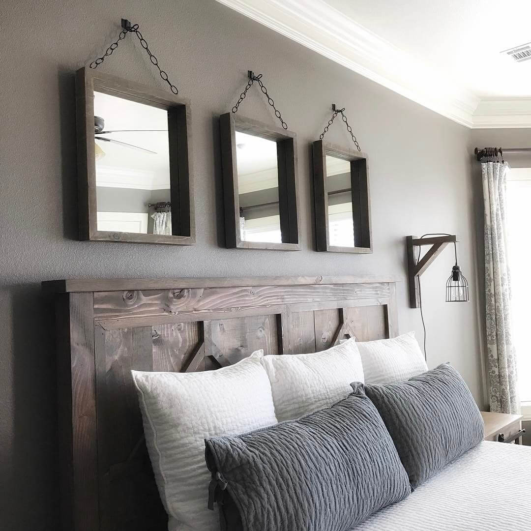 A triplet of mirrors hanging above a headboard can serve as a focal point.