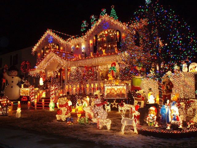 Gaudy outdoor Christmas lights and Santa display.