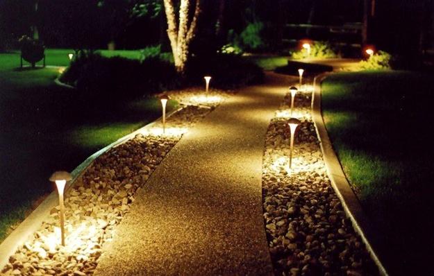 Lead buyers to the front door with night lighting along the walkway.