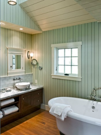 Painting wood paneling in a bathroom.