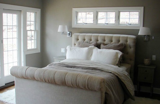 The thick, heavily padded bed footboard takes up too much space in this small room.