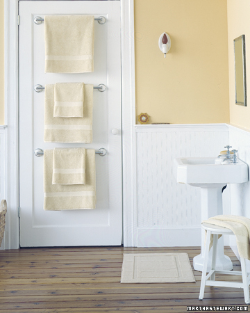 Hang towels bars behind the bathroom door for extra storage.