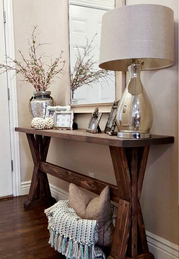 Foyer table with lamps and picture frames.