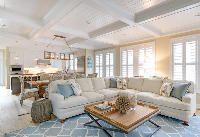 White open concept kitchen and living room with a white coffered ceiling.