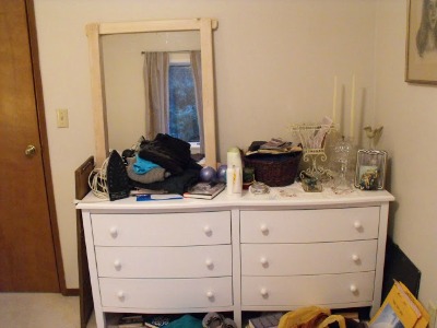 Cluttered bedroom dresser, before.