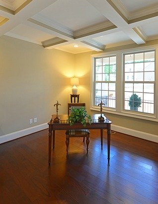 Office interior staged with just a desk and a chair.