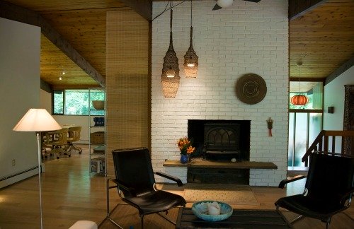 White painted floor to ceiling brick fireplace becomes a feature wall.