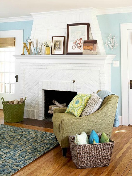 White painted fireplace gives this living room a cozy cottage feel.