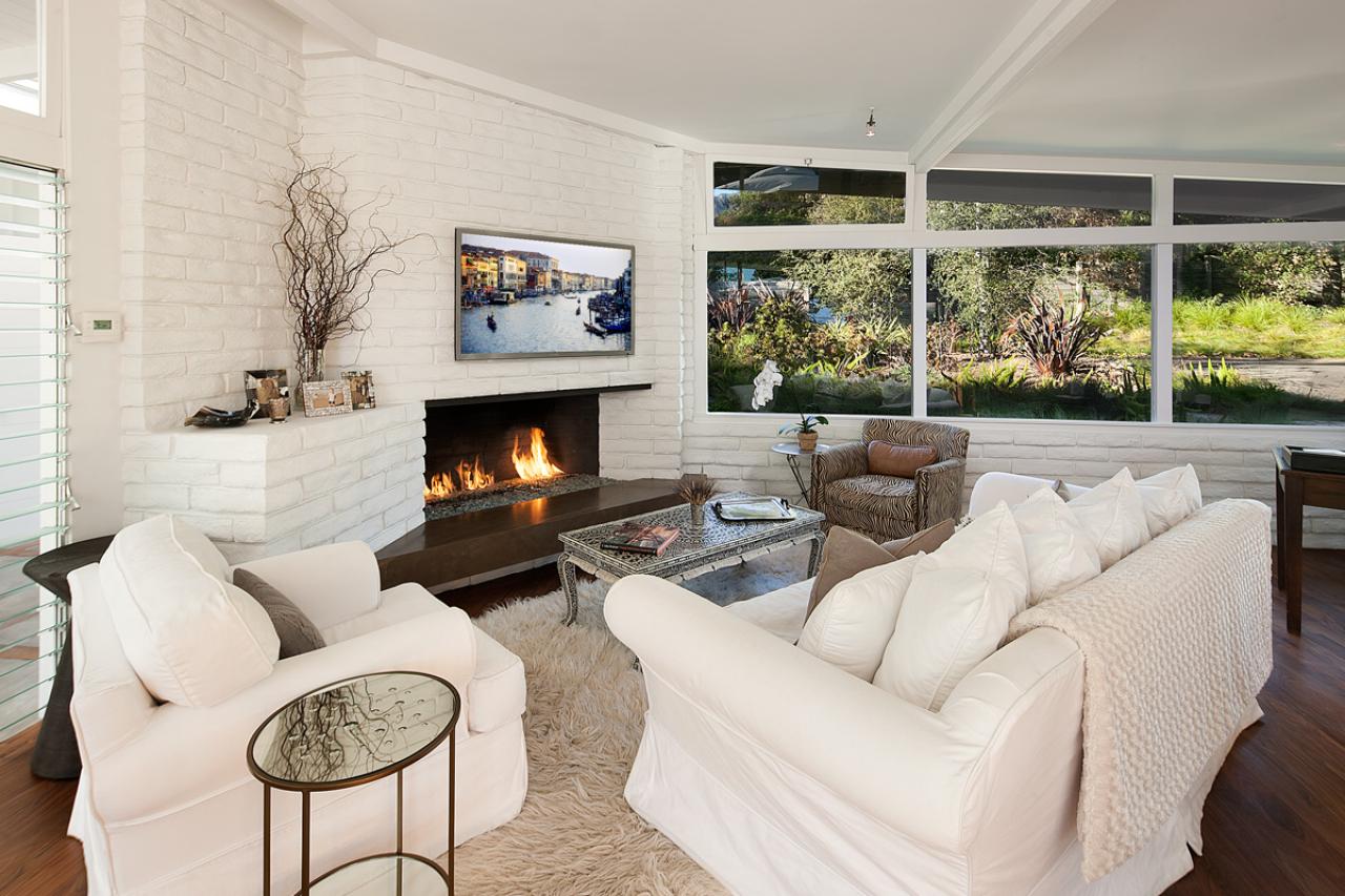 Brick fireplace and wall painted white.