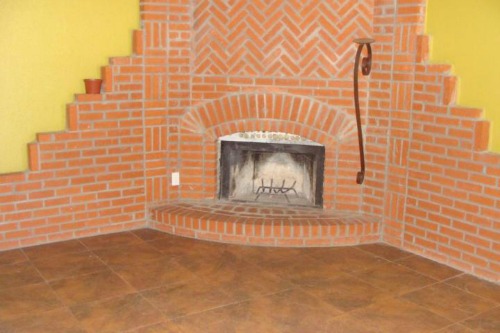 To disguise an ugly brick fireplace, paint the brick the same neutral color as the adjacent walls to make it blend in.