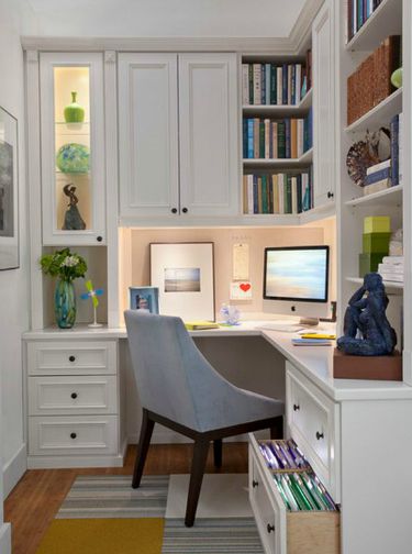 Home office with white cabinetry.