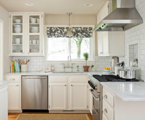 Patterned window treatments add life to this small kitchen.