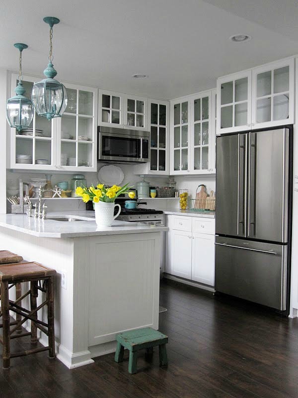 Use glass-fronted cabinetry to extend site lines to the wall.