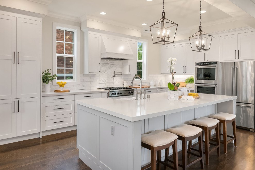 A beautifully staged white kitchen with an island.