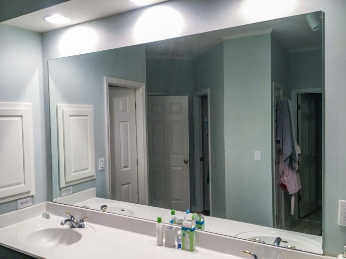 Builder's grade mirror in the bathroom.
