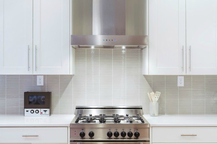 Pretty white glass tiled kitchen.