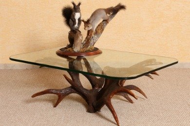 This tacky squirrel and antler coffee table is way too taste specific.