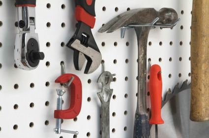 Organize tools in the garage with pegboard.